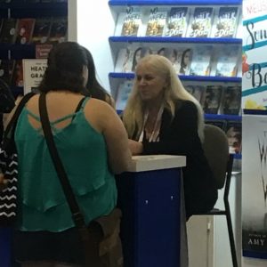 My husband snapped a picture when he caught me at the Harlequin booth. (Me meeting Heather Graham)